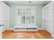 Empty walk-in closet with hardwood floors, white built-in shelving, and a window at 1169 Dawn View Nw Ln, Atlanta, GA 30327