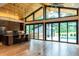 Modern living room featuring a wood ceiling, hardwood floors, and expansive sliding glass doors to the pool at 246 Garland Ave, Decatur, GA 30030