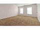 Spacious bedroom with neutral carpet, light walls, and plenty of natural light at 4150 Cedar Bridge Walk, Suwanee, GA 30024