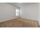 Cozy bedroom featuring neutral carpet, light walls, and a window at 4150 Cedar Bridge Walk, Suwanee, GA 30024