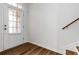 Bright entryway featuring a white door and wood-look flooring with stairs nearby at 4150 Cedar Bridge Walk, Suwanee, GA 30024