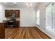 Kitchen area with stainless steel appliances, granite countertops, hardwood floors, and natural light at 4150 Cedar Bridge Walk, Suwanee, GA 30024