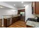 Gourmet kitchen featuring stainless steel appliances, granite countertops, and rich wood cabinetry at 4150 Cedar Bridge Walk, Suwanee, GA 30024