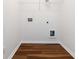 Laundry room with wood floors, a utility sink, and washer/dryer hookups at 4150 Cedar Bridge Walk, Suwanee, GA 30024