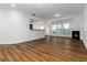 Spacious living room featuring hardwood floors, a cozy fireplace, and an open layout at 4150 Cedar Bridge Walk, Suwanee, GA 30024