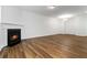 Cozy living room with hardwood floors and a fireplace, offering a warm and inviting space at 4150 Cedar Bridge Walk, Suwanee, GA 30024
