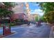 View of the gated entrance to a community, with lush landscaping and multi-story buildings visible in the background at 4333 Dunwoody Park # 2107, Atlanta, GA 30338