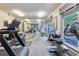 Well-equipped gym with treadmills, exercise bikes, weights, mirrored wall, and large windows for natural light at 4333 Dunwoody Park # 2107, Atlanta, GA 30338