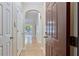 Hallway with hardwood floors, a brown entry door and arched doorways leading to other rooms at 4333 Dunwoody Park # 2107, Atlanta, GA 30338