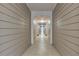 Long hallway with beige plank walls and off-white tile flooring, leading to a bright entrance at 4333 Dunwoody Park # 2107, Atlanta, GA 30338