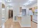 Cozy kitchen with wood cabinets, white appliances, and laminate flooring flowing into the dining area at 4333 Dunwoody Park # 2107, Atlanta, GA 30338