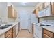 Functional kitchen with white appliances, wood cabinetry, and ample counter space for meal preparation at 4333 Dunwoody Park # 2107, Atlanta, GA 30338