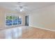 Bright living room features hardwood floors, a ceiling fan, and a large window for plenty of natural light at 4333 Dunwoody Park # 2107, Atlanta, GA 30338