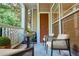 Staged covered patio with table and seating and a view of the surrounding greenery at 4333 Dunwoody Park # 2107, Atlanta, GA 30338