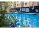Close-up of a swimming pool surrounded by lounge chairs, greenery, and condo buildings in the background at 4333 Dunwoody Park # 2107, Atlanta, GA 30338