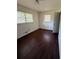 Bedroom featuring laminate flooring, light fixture, and dual windows at 4416 Arcadia Dr, Norcross, GA 30093