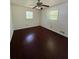 Bedroom featuring two windows, a ceiling fan, and dark laminate flooring at 4416 Arcadia Dr, Norcross, GA 30093