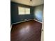 Bedroom featuring laminate flooring, light fixture, and ample light from the window at 4416 Arcadia Dr, Norcross, GA 30093