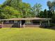 Charming brick home featuring a covered front porch and well-manicured lawn at 4416 Arcadia Dr, Norcross, GA 30093