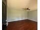 A spacious living room features a ceiling fan and dark laminate flooring at 4416 Arcadia Dr, Norcross, GA 30093