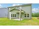 Green two-story home with covered back patio and ample yard space at 5377 Heron Bay Blvd, Locust Grove, GA 30248
