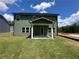 Expansive backyard featuring lush lawn and a covered patio, perfect for outdoor relaxation and entertaining at 5377 Heron Bay Blvd, Locust Grove, GA 30248