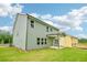 Green two-story home with covered back patio and ample yard space at 5377 Heron Bay Blvd, Locust Grove, GA 30248