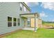 Green two-story home with covered back patio and ample yard space at 5377 Heron Bay Blvd, Locust Grove, GA 30248