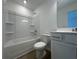 A pristine bathroom featuring a shower-tub combo, toilet, and vanity with modern fixtures at 5377 Heron Bay Blvd, Locust Grove, GA 30248