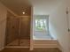 Luxurious bathroom features separate shower and tub with a window at 5377 Heron Bay Blvd, Locust Grove, GA 30248