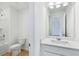 Bright bathroom showcasing a vanity with storage, a toilet, and a shower-tub combination at 5377 Heron Bay Blvd, Locust Grove, GA 30248
