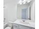 Bright bathroom featuring a large mirror, white vanity, and bathtub with shower at 5377 Heron Bay Blvd, Locust Grove, GA 30248