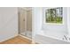 Modern bathroom features a tub and separate glass-enclosed shower at 5377 Heron Bay Blvd, Locust Grove, GA 30248