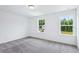 Bright bedroom filled with natural light from two windows overlooking the lush surroundings at 5377 Heron Bay Blvd, Locust Grove, GA 30248