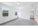 Comfortable bedroom showcasing plush carpeting, two windows, and convenient access to an ensuite bathroom at 5377 Heron Bay Blvd, Locust Grove, GA 30248