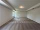 Spacious bedroom with tray ceiling and neutral carpet at 5377 Heron Bay Blvd, Locust Grove, GA 30248