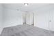Spacious bedroom featuring soft carpet, multiple doors, and a versatile layout for furniture arrangement at 5377 Heron Bay Blvd, Locust Grove, GA 30248