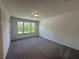 Bedroom featuring plush carpeting and natural light from a large window at 5377 Heron Bay Blvd, Locust Grove, GA 30248