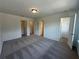 Bedroom featuring plush carpeting and multiple access doors at 5377 Heron Bay Blvd, Locust Grove, GA 30248