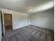 Bedroom with plush carpeting, and multiple access doors at 5377 Heron Bay Blvd, Locust Grove, GA 30248
