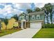 Charming two-story home features a stone and siding exterior, attached two-car garage, and well-manicured lawn at 5377 Heron Bay Blvd, Locust Grove, GA 30248