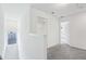 Upstairs hallway with view to outside; doorway leads to carpeted bedroom at 5377 Heron Bay Blvd, Locust Grove, GA 30248