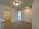 Hallway featuring plush carpet and access to multiple rooms at 5377 Heron Bay Blvd, Locust Grove, GA 30248