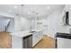 Contemporary kitchen showcasing an island with sink, stainless steel appliances and bright white cabinets at 5377 Heron Bay Blvd, Locust Grove, GA 30248