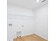 Clean laundry room with wood-look flooring and wire shelving at 5377 Heron Bay Blvd, Locust Grove, GA 30248