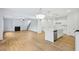 Open-concept living space with a kitchen island, fireplace, and staircase at 5377 Heron Bay Blvd, Locust Grove, GA 30248