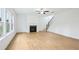Living room featuring a fireplace, staircase, and large windows with natural light at 5377 Heron Bay Blvd, Locust Grove, GA 30248