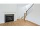 Bright living room featuring a fireplace, hardwood floors and staircase with modern balusters at 5377 Heron Bay Blvd, Locust Grove, GA 30248