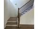 Modern staircase with wood and black iron railing at 5377 Heron Bay Blvd, Locust Grove, GA 30248