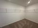 Spacious walk-in closet featuring carpet flooring and wire shelving for optimal organization at 5377 Heron Bay Blvd, Locust Grove, GA 30248